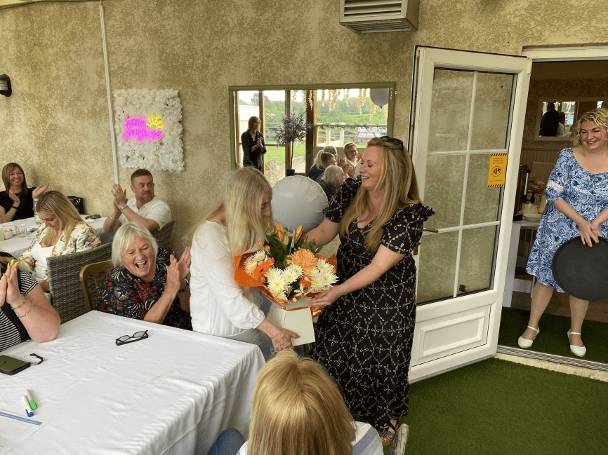 Anne sherry, foster carer, receiving retirement flowers 